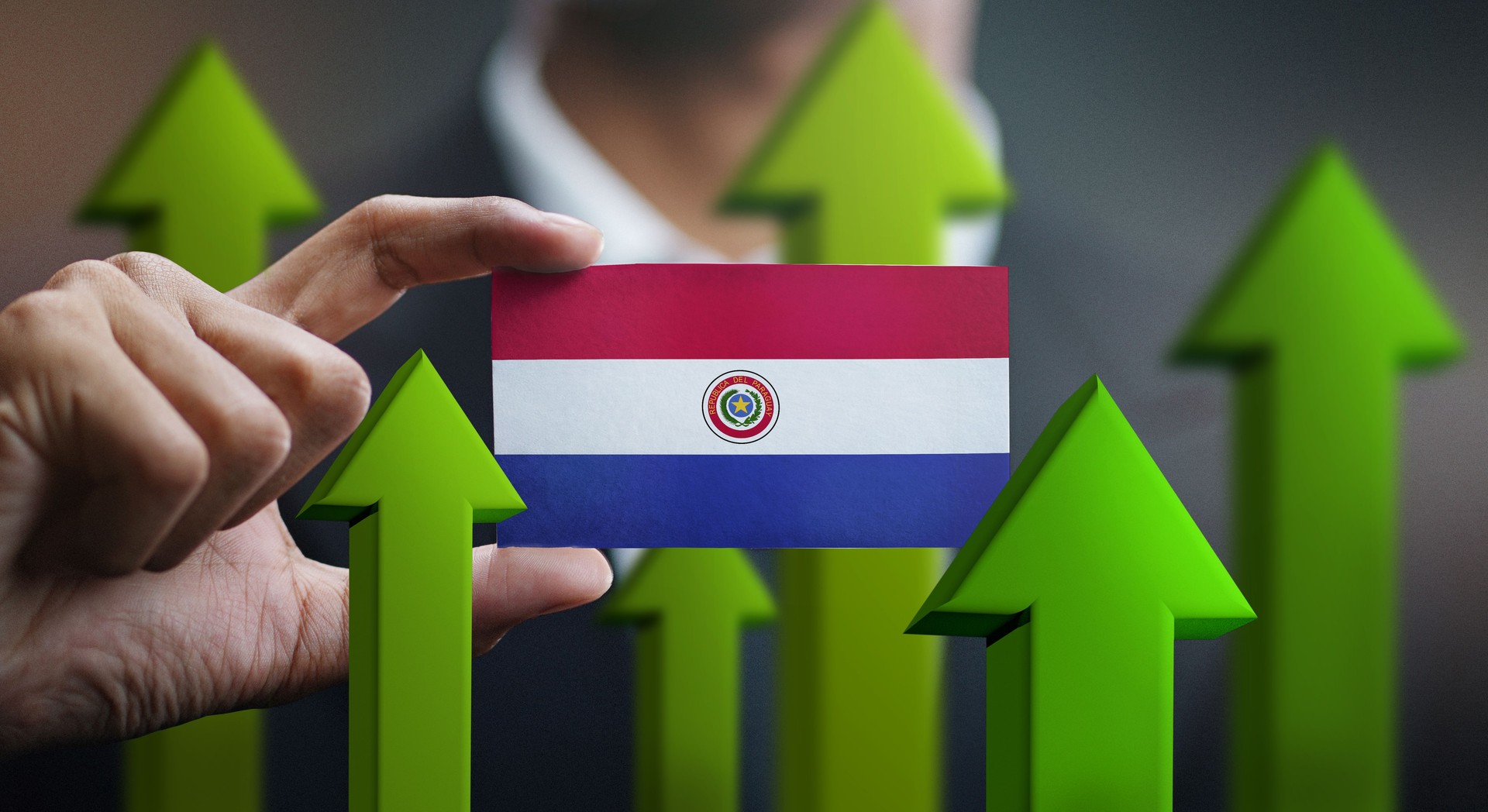 Nation Growth Concept, Green Up Arrows - Businessman Holding Card Paraguay Flag